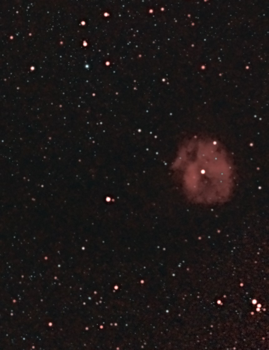 The Cocoon Nebula (IC 5146) photographed from Lakeway, Texas with a ZWO Seestar S50 — a small rounded glow of red hydrogen around a bright central star, with dark dust lanes across it, in a dense Cygnus star field.