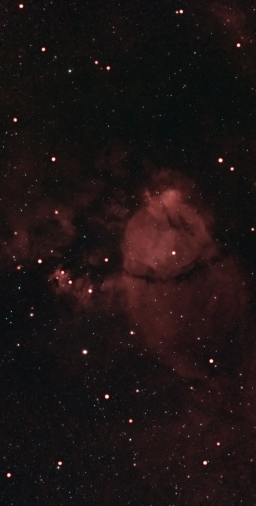 The Fishhead Nebula (IC 1795) photographed from Lakeway, Texas with a ZWO Seestar S50: a rounded glow of red hydrogen at the center shaped like a fish’s head and crossed by a dark dust lane, with the bright knot NGC 896 just above it and fainter red wisps around it.