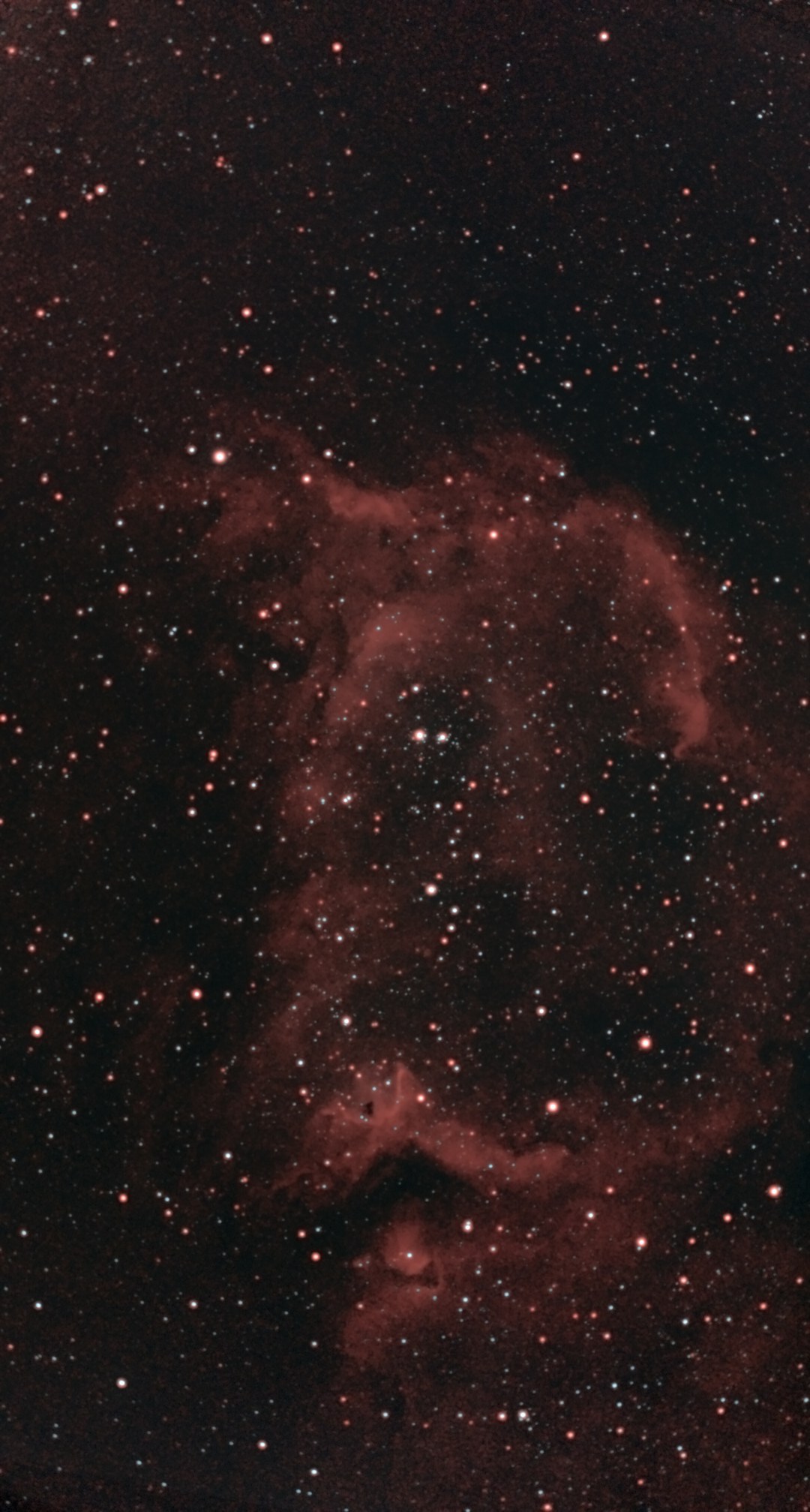 The Soul Nebula (IC 1848) photographed from Lakeway, Texas with a ZWO Seestar S50 Pro — a vast, smoky red emission nebula filling the frame, its blown-out bubble walls cut by dark bays, with young star clusters scattered through the interior.