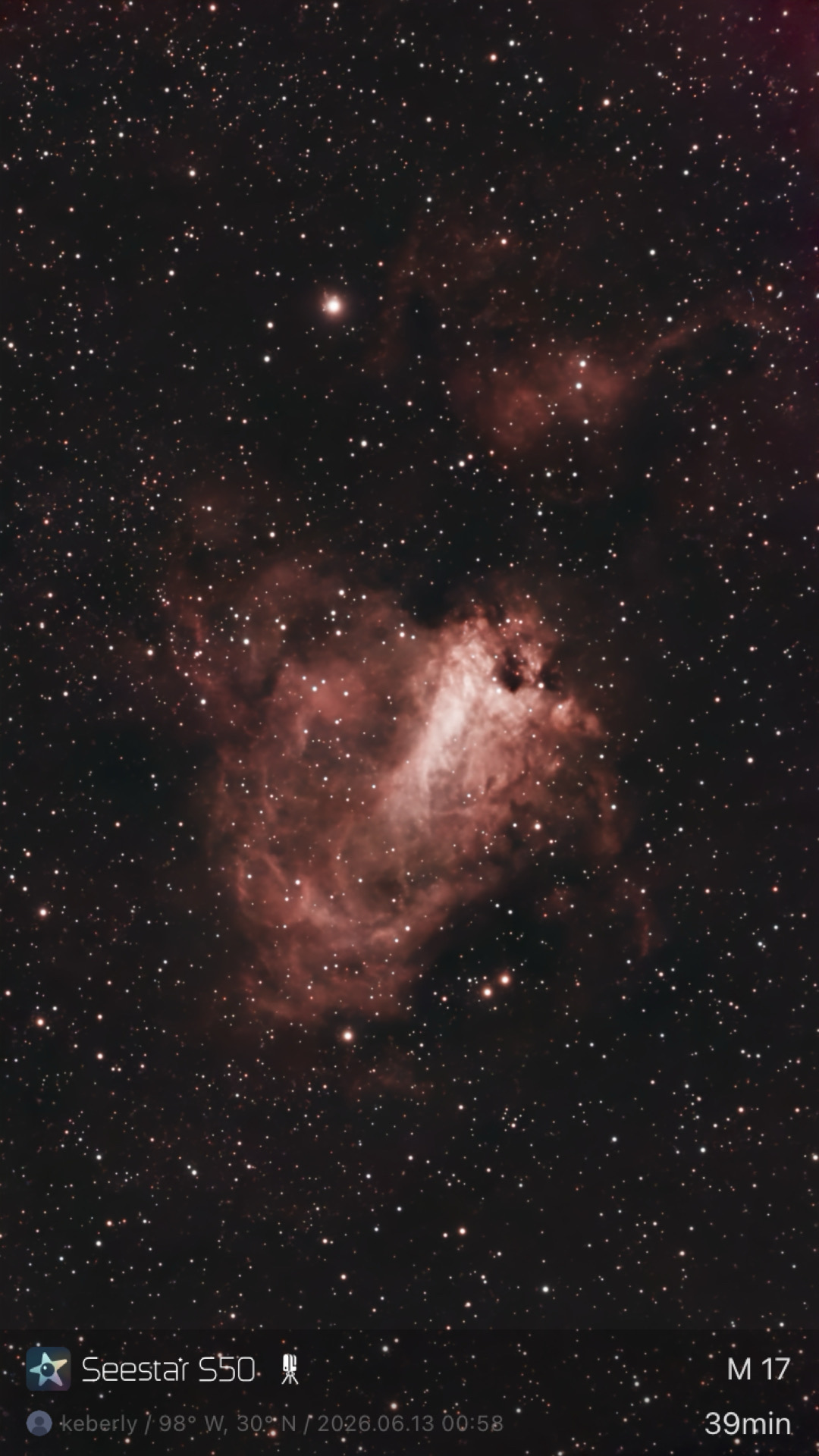 The Omega (Swan) Nebula (M17) photographed from Lakeway, Texas with a ZWO Seestar S50 — a bright pink emission nebula with a swan-shaped central bar and surrounding nebulosity.