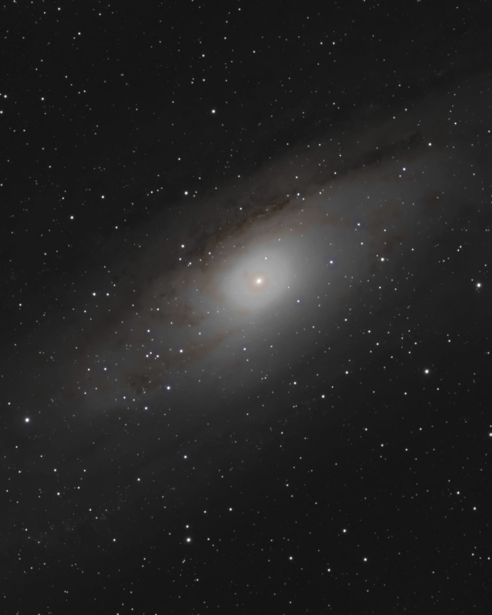 The Andromeda Galaxy (M31) photographed from Lakeway, Texas with a ZWO Seestar S50 — a huge inclined spiral galaxy with dark dust lanes and a bright golden core, its disk running across the full frame.