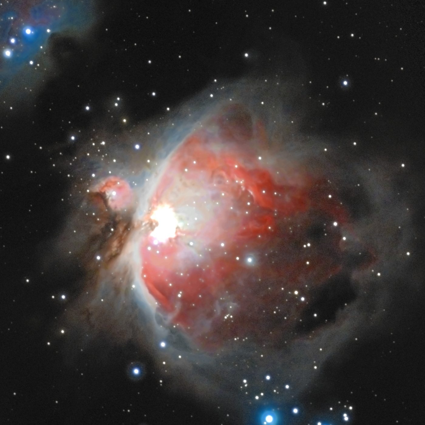 The Orion Nebula (M42) photographed from Lakeway, Texas with a ZWO Seestar S50 — pink hydrogen wings and a blue interior glow around the bright Trapezium core, with the dark Fish’s Mouth dust lane and companion nebula M43.