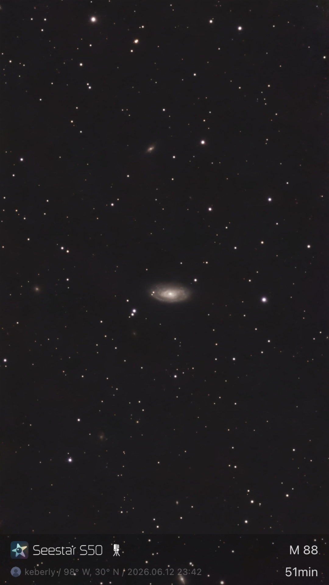 M88 photographed from Lakeway, Texas with a ZWO Seestar S50 — a face-on spiral galaxy in the Virgo Cluster, with several smaller background galaxies scattered across the frame.