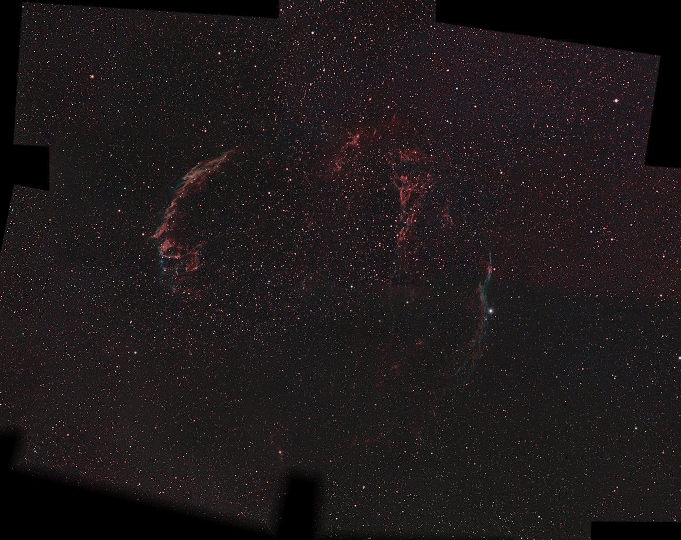 The Veil Nebula mosaic assembled from nineteen Seestar panels: the full loop of red and teal filaments, filled out to a complete rectangle with evened-out sky.